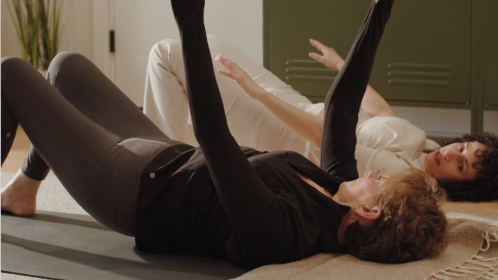 Yoga therapist Christine Saari uses directed awareness techniques with a client to reduce low back pain