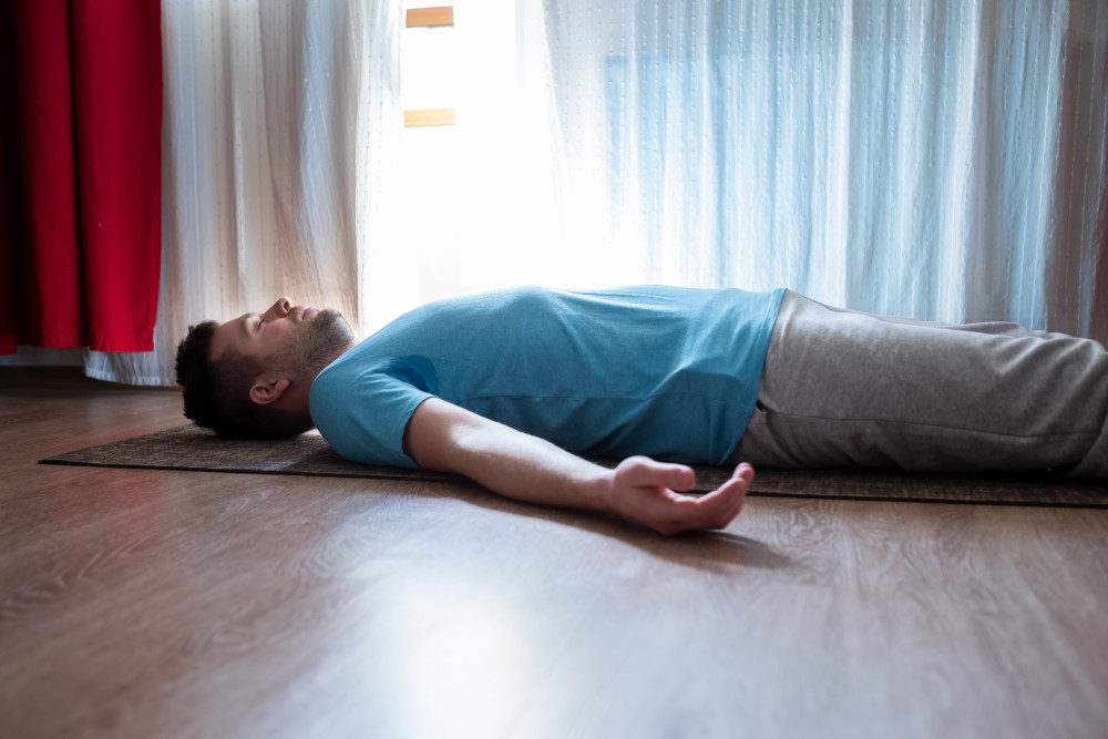 Man performing prana nidra (yoga nidra) for chronic fatigue